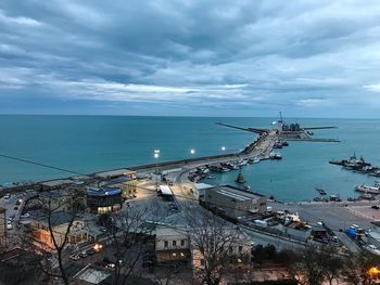 High angle view of cityscape by sea against sky