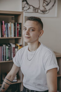 Portrait of young man standing at home