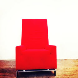 Close-up of red chair against white background