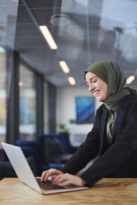 Woman in office using laptop