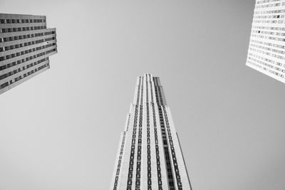 Directly below shot of buildings in city against sky