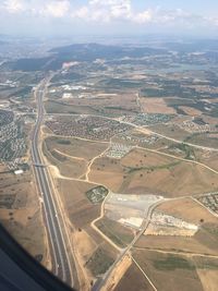 Aerial view of city seen through airplane window