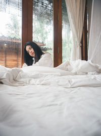 Woman relaxing on bed at home