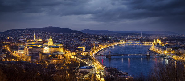 High angle view of illuminated cityscape against sky at night