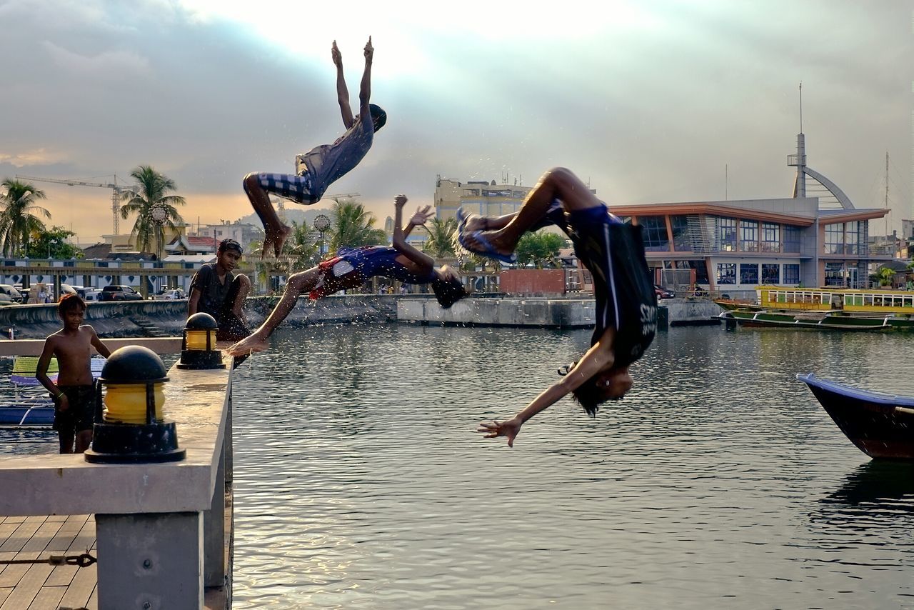 water, sky, building exterior, architecture, built structure, men, cloud - sky, nautical vessel, lifestyles, river, person, leisure activity, waterfront, large group of people, sculpture, cloud, travel, tourism, travel destinations