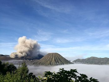 Scenic view of volcano in the fog against cloudy sky