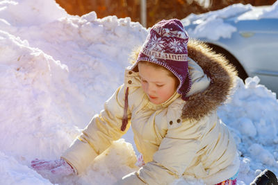 Cute girl standing outdoors during winter