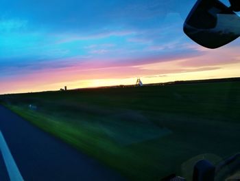 Scenic view of field against sky during sunset