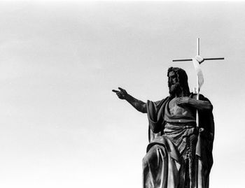 Low angle view of woman standing against wall