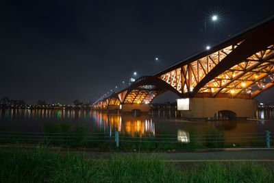 Illuminated train against sky at night