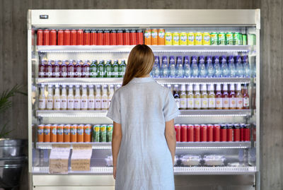 Woman standing in front of refrigerator in cafeteria