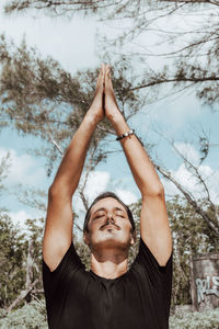 Portrait of young man doing yoga 