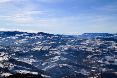 Aerial view of snowcapped mountains against sky