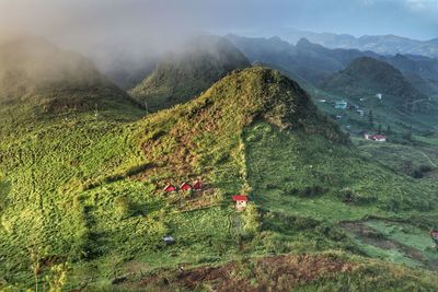 High angle view of green landscape against sky