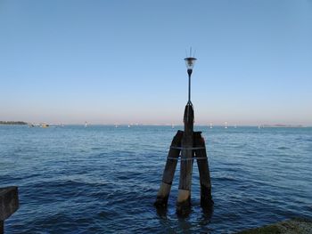 Scenic view of sea against clear blue sky