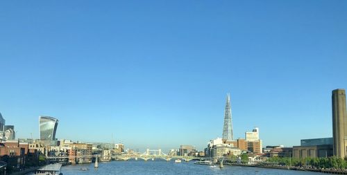 Buildings in city against blue sky