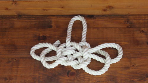 Close-up of white rope on wooden surface