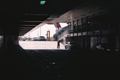 Man walking on street amidst buildings in city