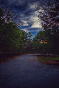 Empty road against cloudy sky