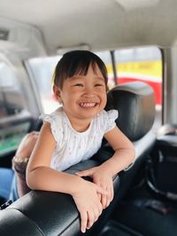 Portrait of a baby girl sitting in car