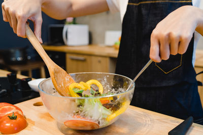 Midsection of person preparing food