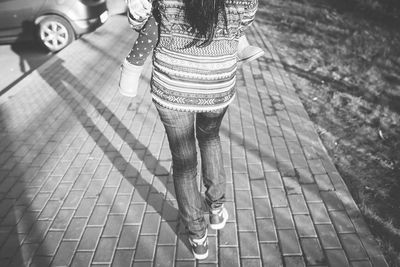 Low section of woman standing on tiled floor