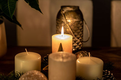 Close-up of illuminated candles on table