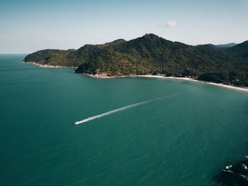 High angle view of sea and mountains against sky