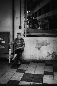 Full length of woman standing by railing