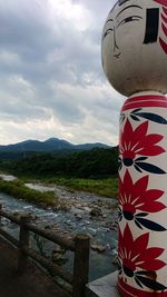 Close-up of flag against mountain range against sky