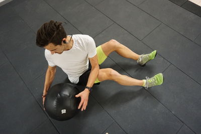 High angle view of man sitting on floor