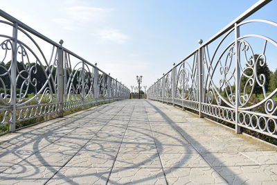 Bridge over footpath against sky