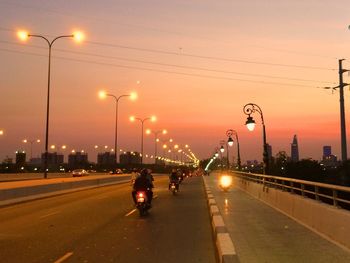 Road passing through city at night