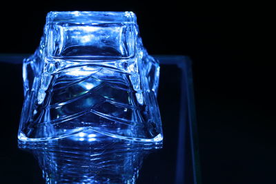 Close-up of drink glass against black background