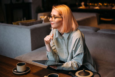 Woman sitting on table