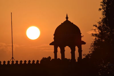 Low angle view of silhouette temple against sky during sunset