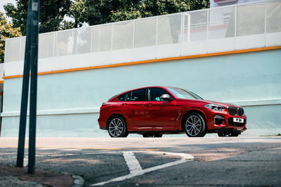 Red car on road against building