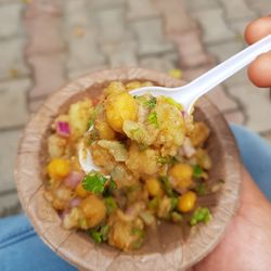 Cropped hand of person holding food