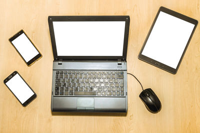 Close-up of laptop on table with digital tablet and smart phone