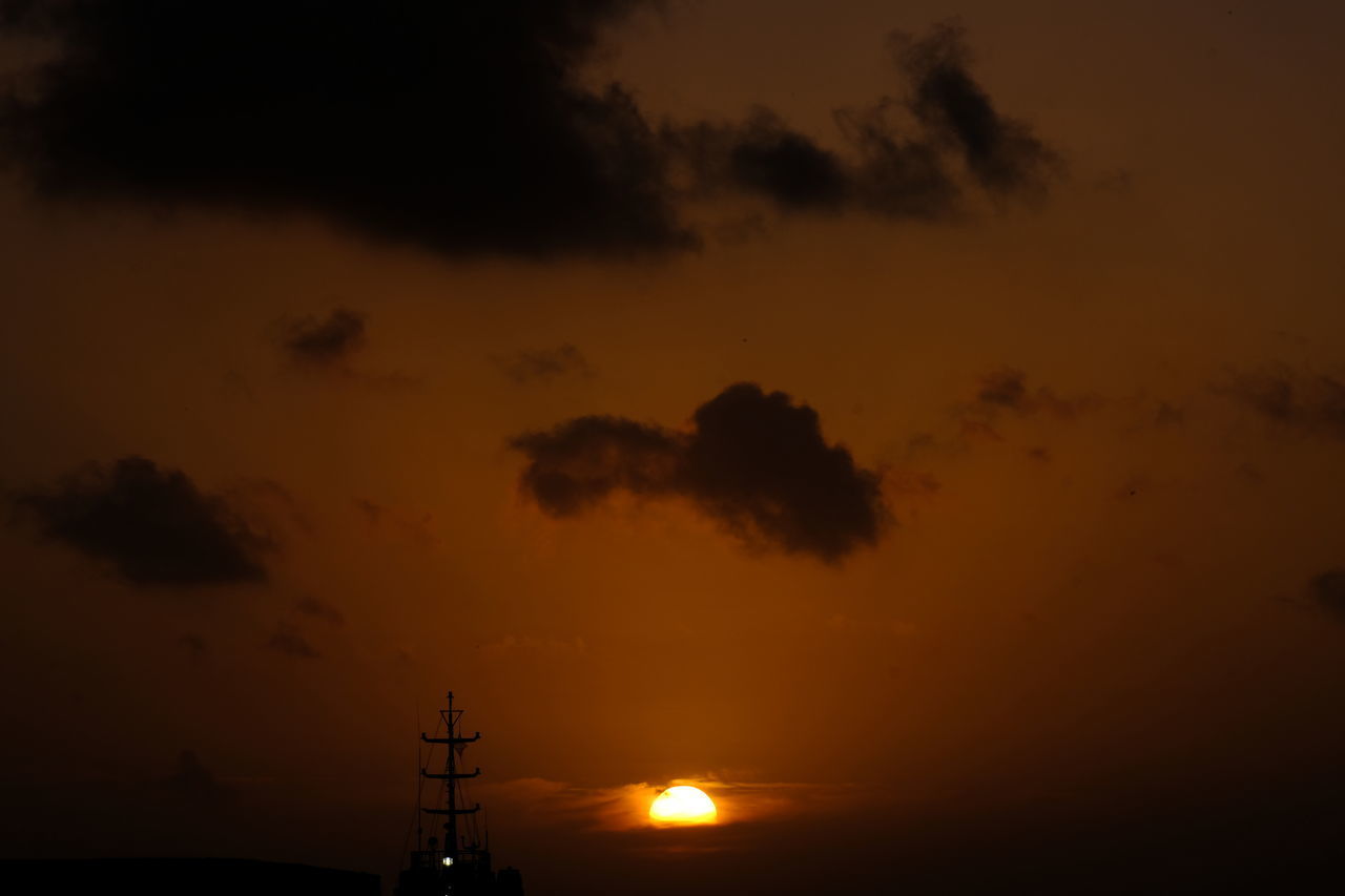 LOW ANGLE VIEW OF SILHOUETTE ELECTRICITY PYLONS AGAINST ORANGE SKY