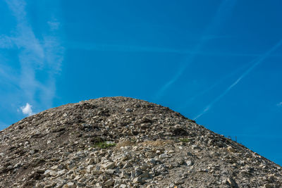 Low angle view of rock formation against blue sky