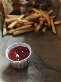 Close-up of ketchup and fries on table