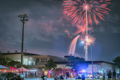 Low angle view of firework display at night