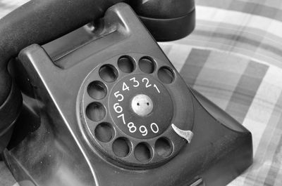 Close-up of old-fashioned telephone on cushion