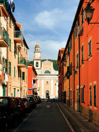 Street amidst buildings in city against sky