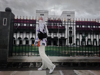 Rear view of man standing against building