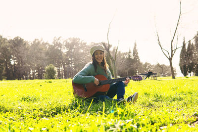 Young woman sitting on field