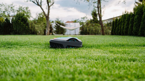 Automatic lawn mower at garden. banner photo