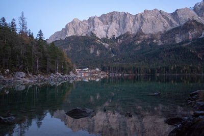 Scenic view of lake and mountains against clear sky