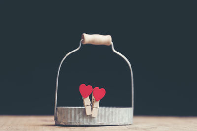 Heart shape on red table against black background